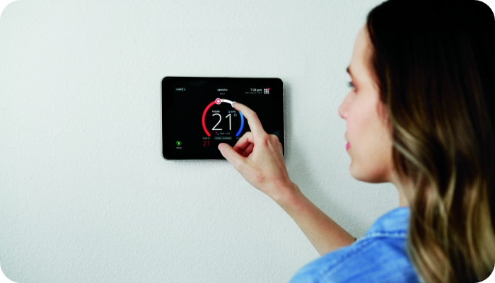 Lennox Brand Thermostat Women Adjusting