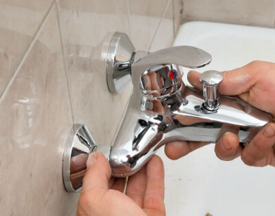 Hands Fixing Faucet