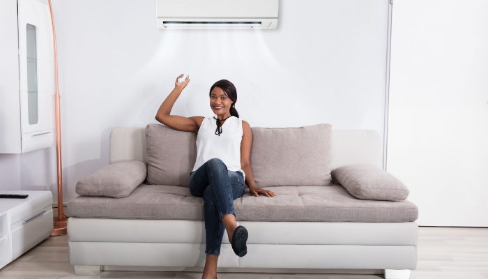 Minispilt Air Conditioner Women Turning On Minispilt Air Conditioner Women Turning On