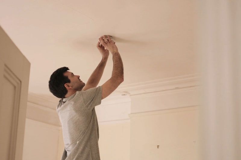 Image of someone changing batteries in smoke detector. Video - When Do I Need to Replace the Batteries in My Smoke Detector?