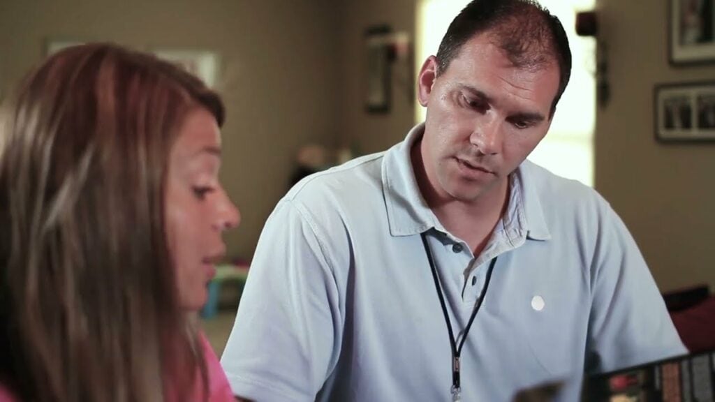 Do I Need to Schedule a Maintenance Appointment? Image of HVAC professional speaking to woman.